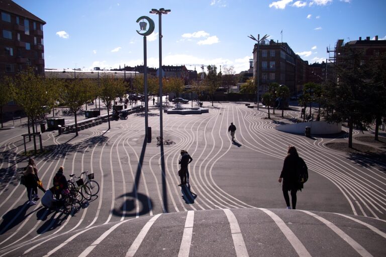 A large paved area where people are biking and skating