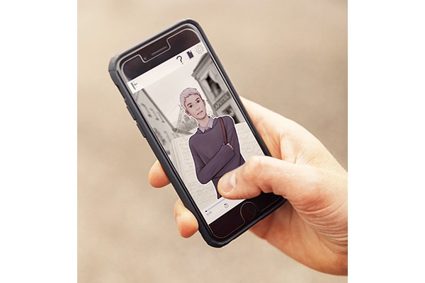 A closeup of a man's hand holding a smartphone. On the screen, an animated character is visible