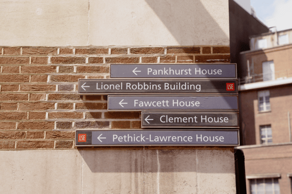 A sign on a brick wall that says Pankhurst house