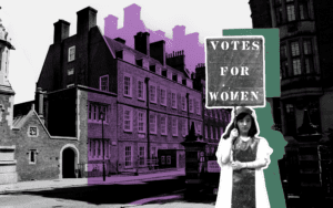 A black and white image of a street in Holborn, London. In the foreground is a young girl holding up a sign that says votes for women.